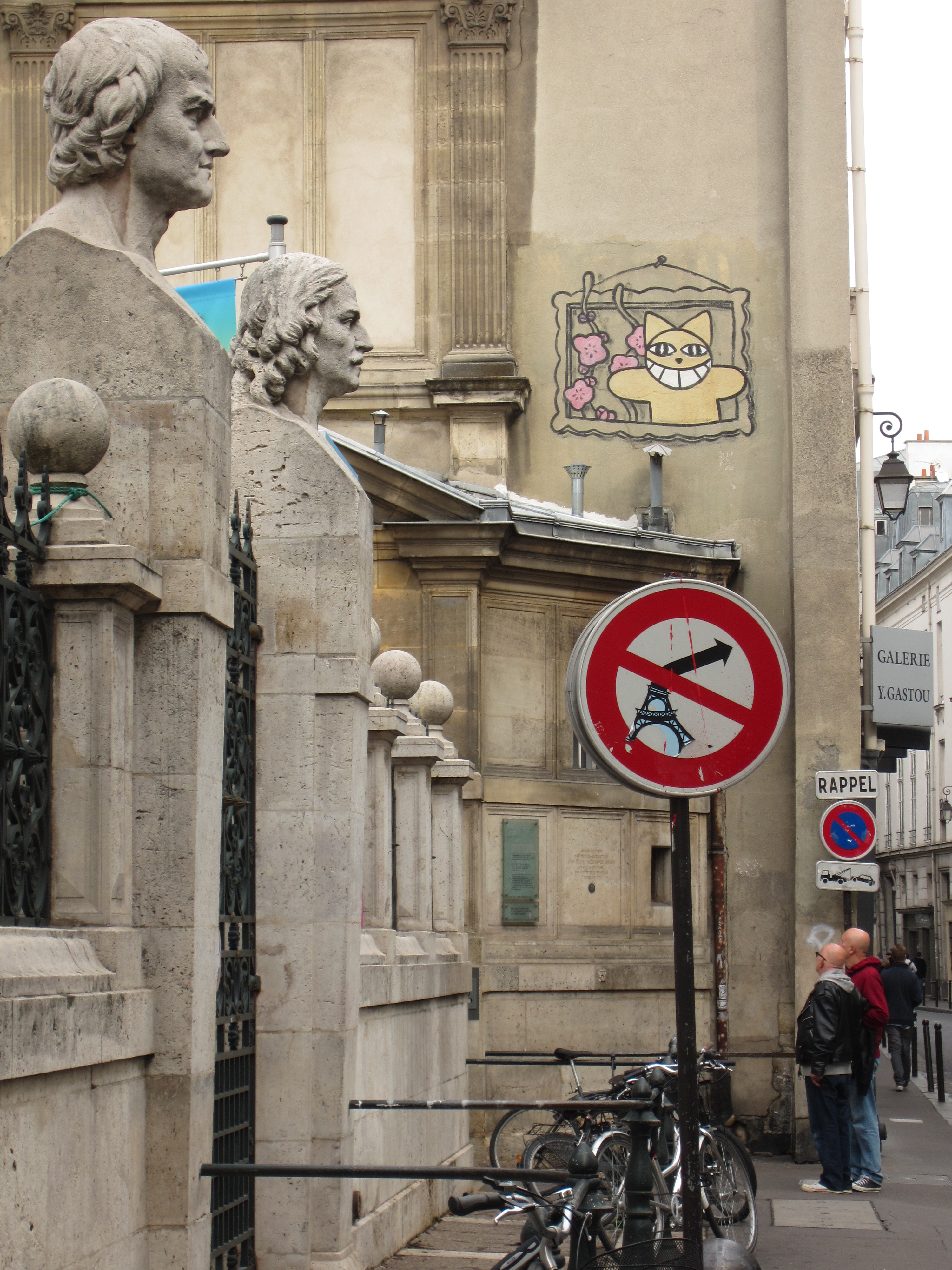a paris street sign graffiti with eiffel tower
