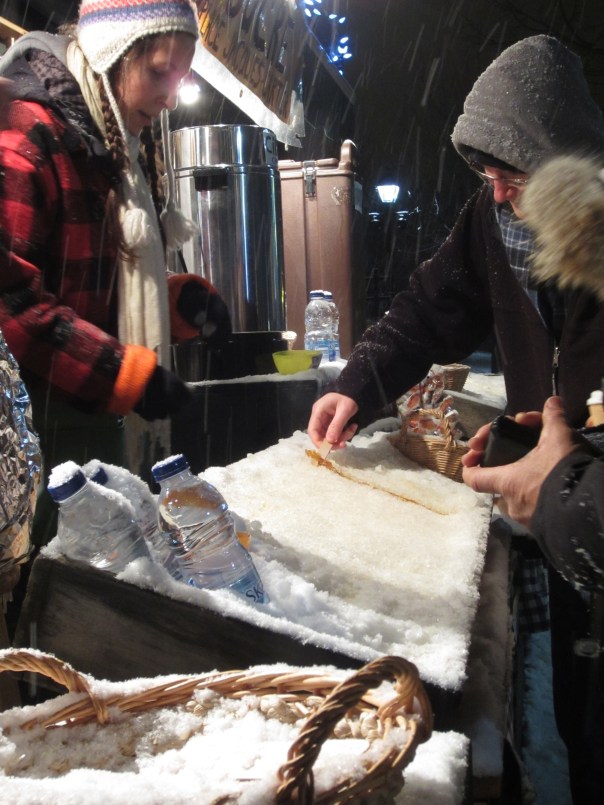 Tire d'erable, (maple syrup taffy), a line of maple syrup poured onto the snow, then rolled up when frozen to make a lolly. This is Canada!