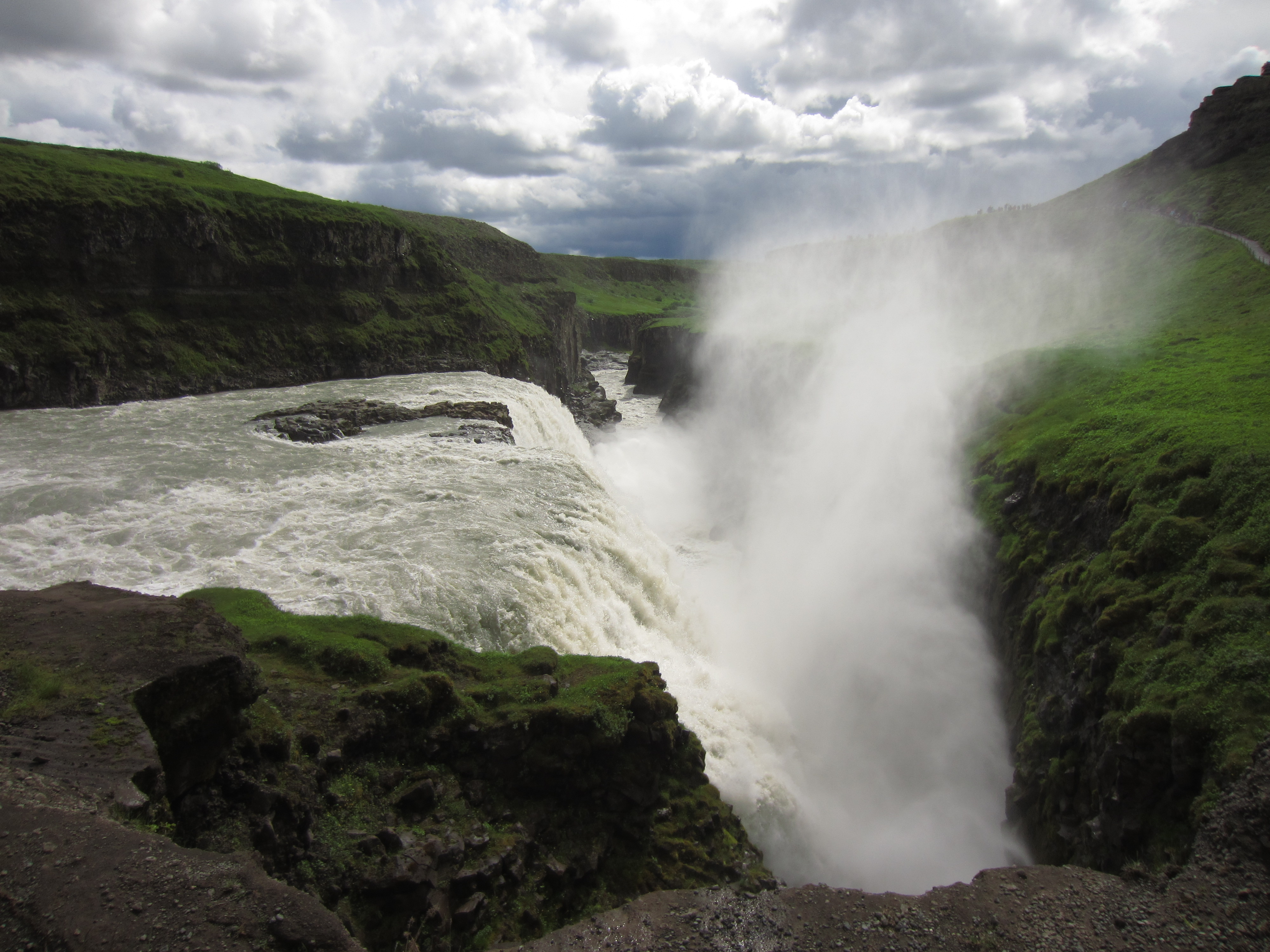 an icelandic waterfall sprays water up
