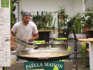 A man cooks a huge plate of paella in biarritz
