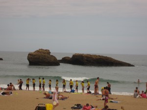 A line of trainee surfers at biarritz beach
