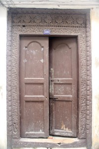 A wooden zanzibar door with one half open