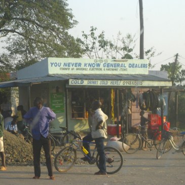 A malawi general store with a group of locals and a bicycle