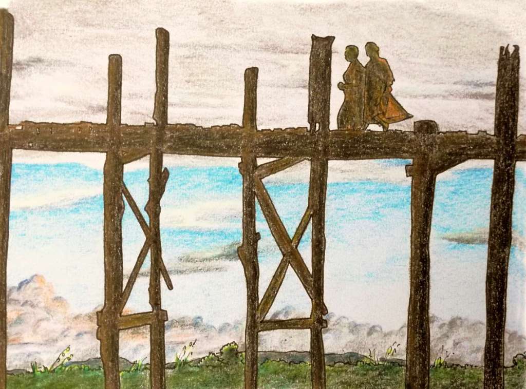 sunset over u bein bridge with monks at dusk